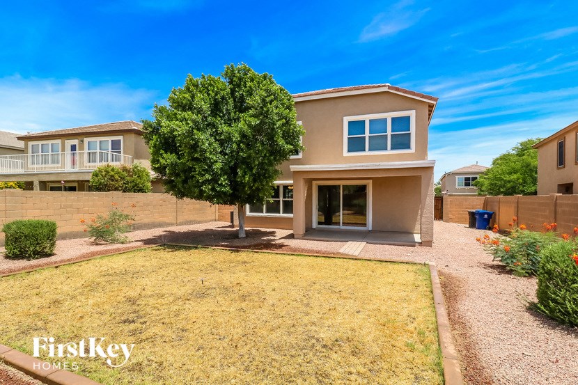 a house with a yard and a tree in front of it