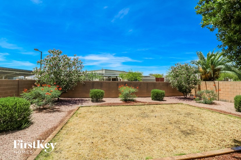 a backyard with a garden and a fence