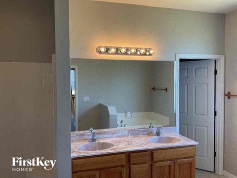 a bathroom with two sinks and a large mirror