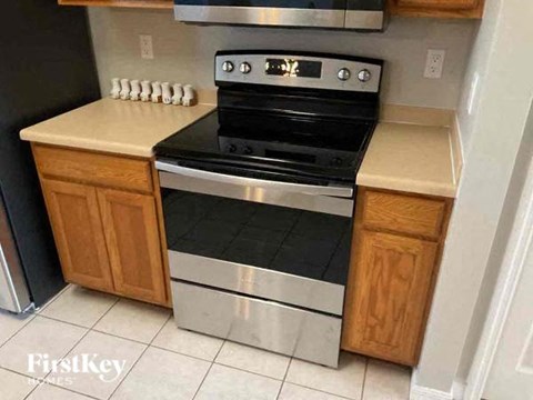 a kitchen with a stove and a refrigerator