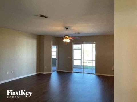 an empty empty living room with a ceiling fan