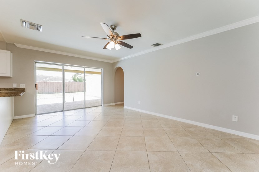 a empty living room with a ceiling fan