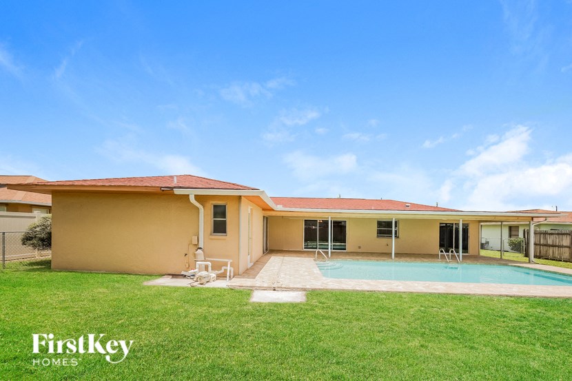 a backyard with a pool and a house
