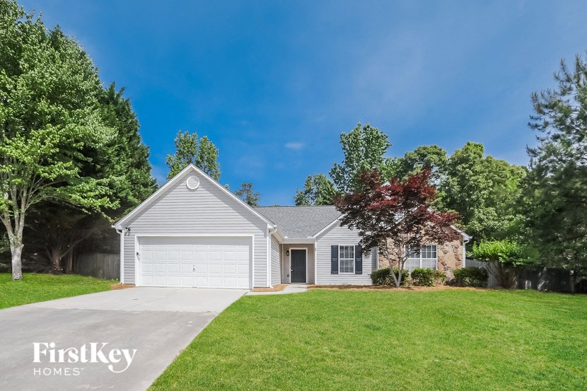 a white house with a lawn and a driveway