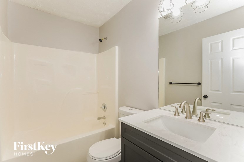a white bathroom with a sink and a toilet
