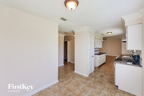 A kitchen area with a counter and cabinets.