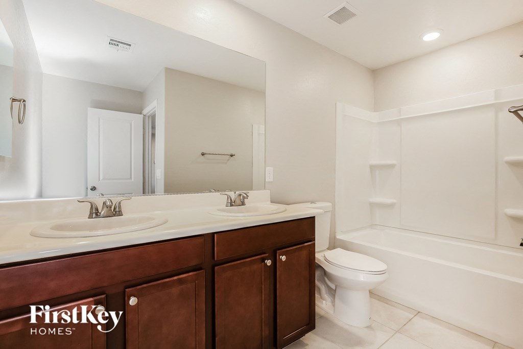 a bathroom with a sink and a toilet and a shower