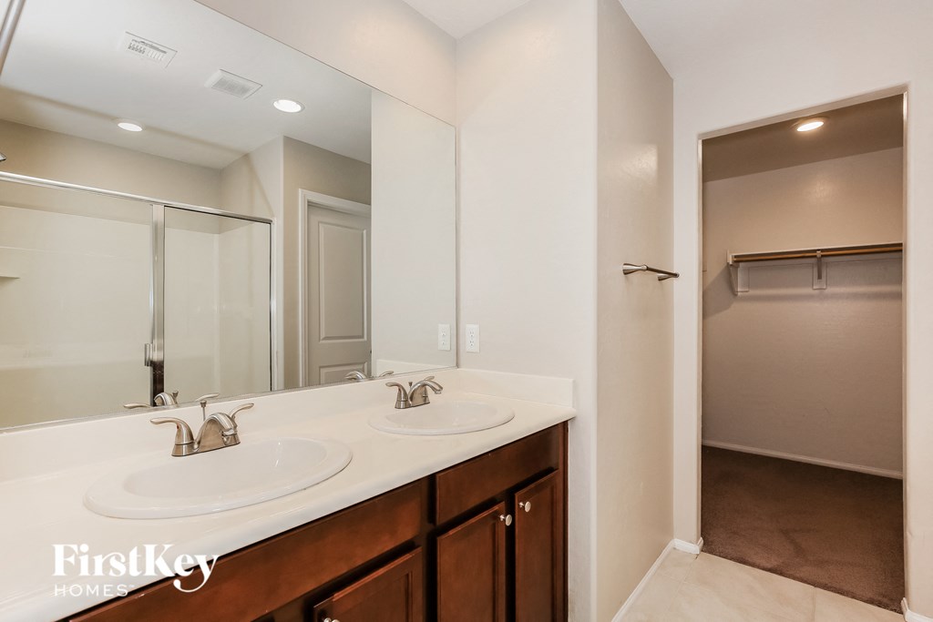 a bathroom with two sinks and a large mirror