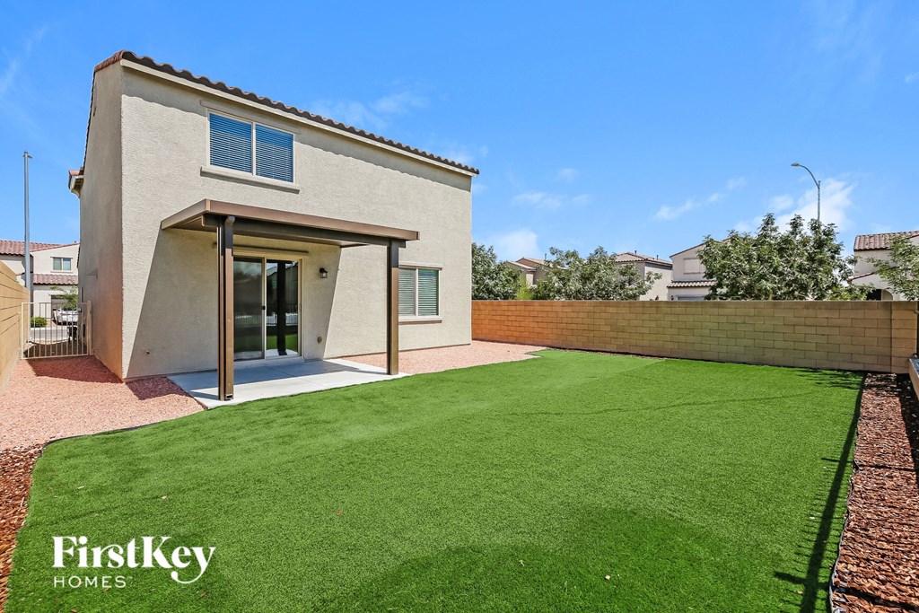 a backyard with a green lawn and a house