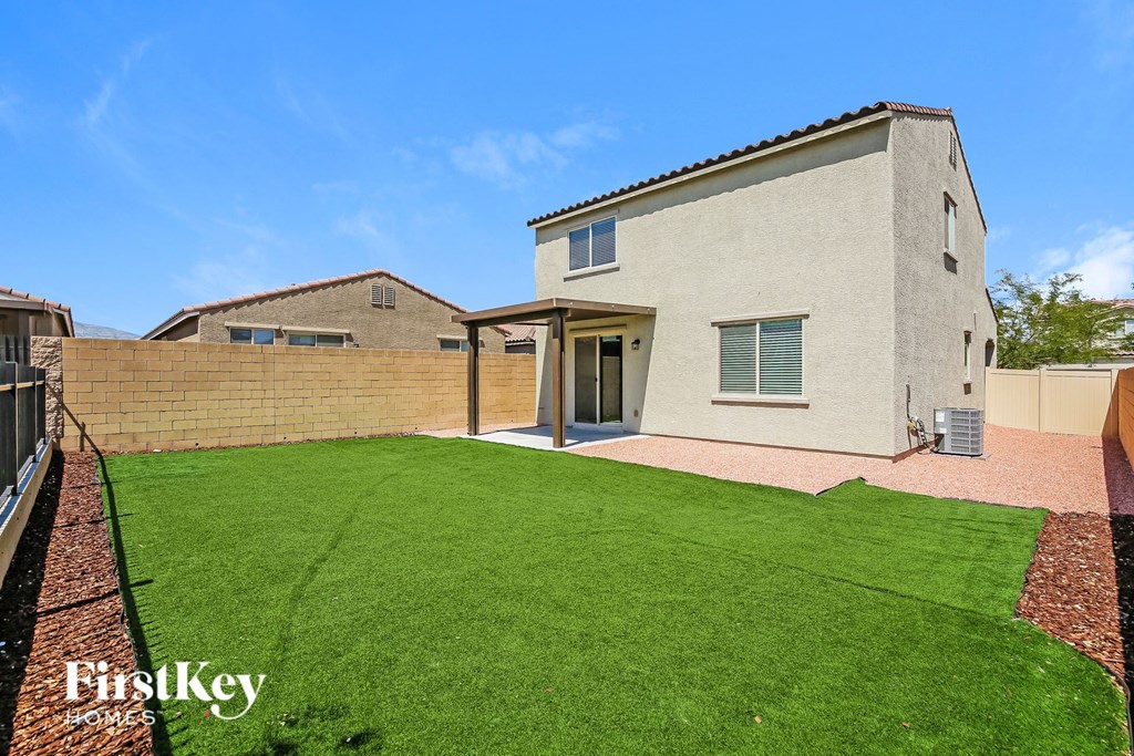 a backyard with a green lawn and a house