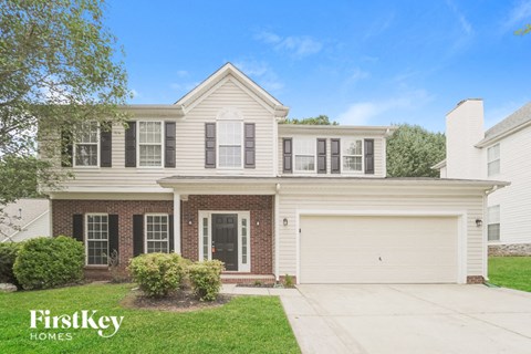 A two-story house with a garage is for sale.