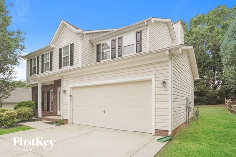 A two-story house with a garage is for sale.