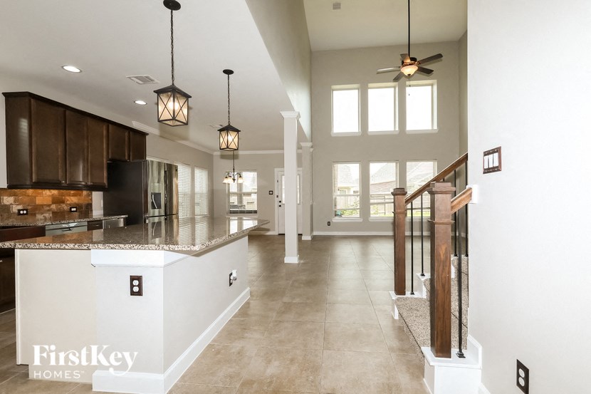 the kitchen and living room of a new house