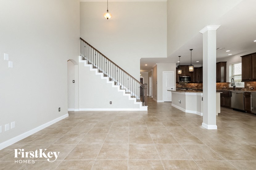 the spacious living room and staircase to the second floor