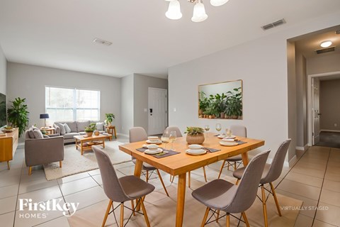 A dining room with a wooden table and chairs.