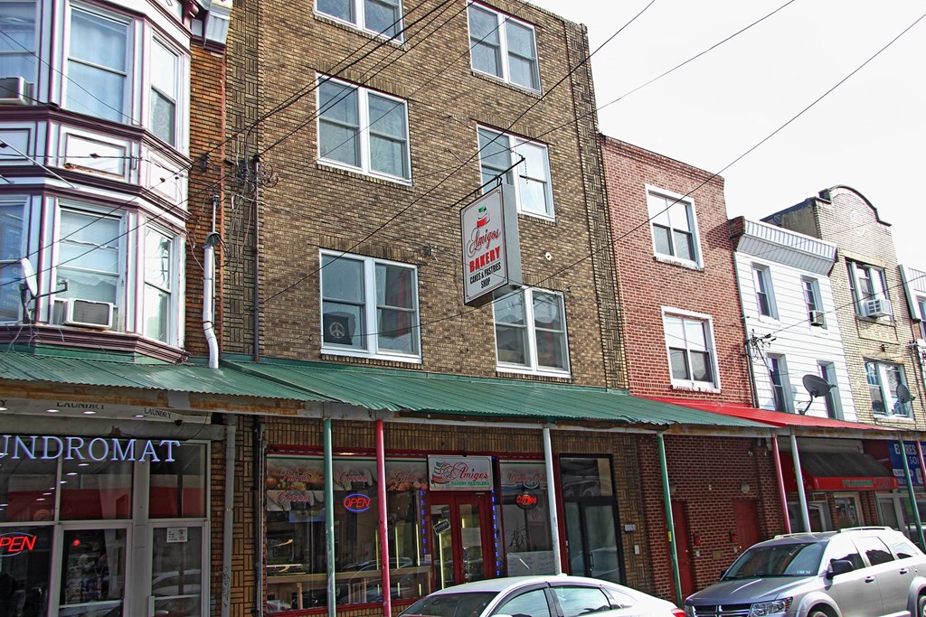 the front of a building with cars parked outside of it