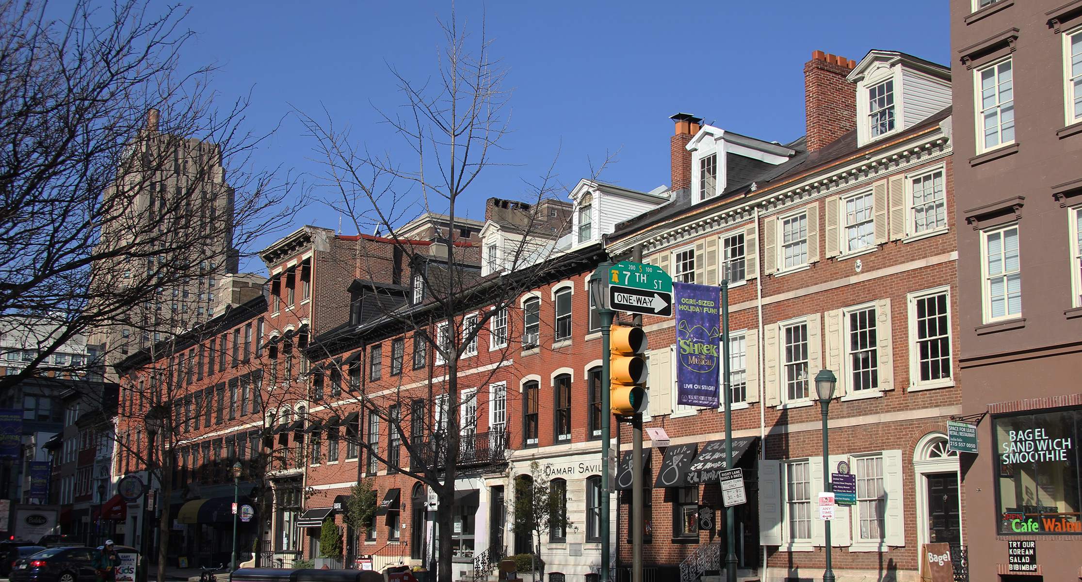 a row of buildings on a city street with a traffic light