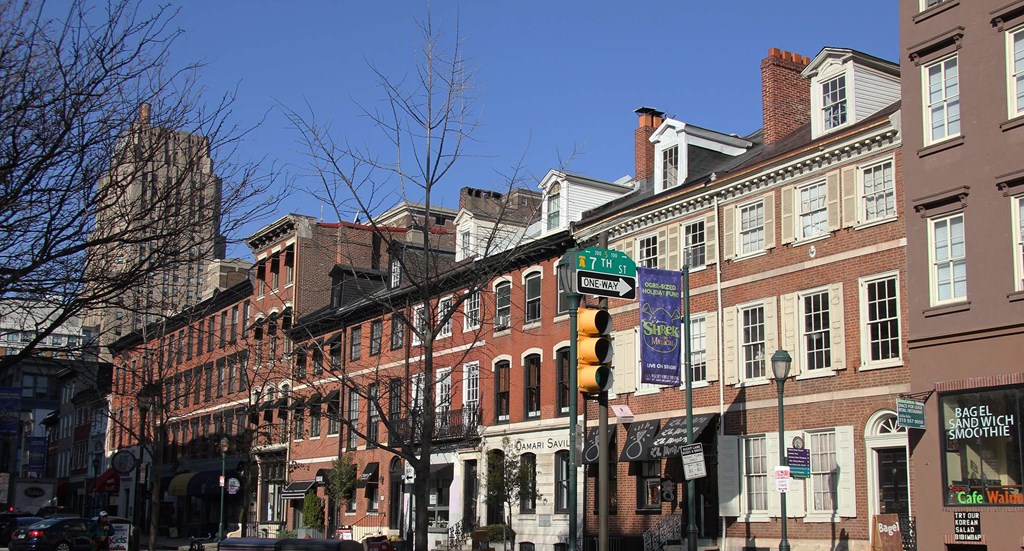a row of buildings on a city street with a traffic light