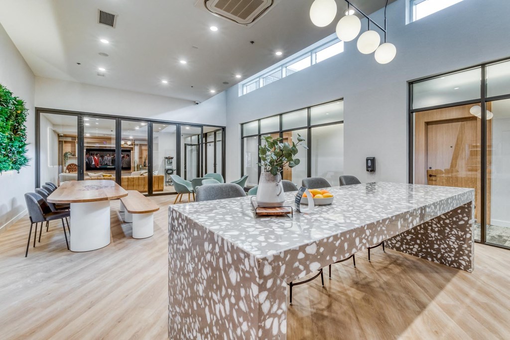 A modern dining room with a large table and chairs.