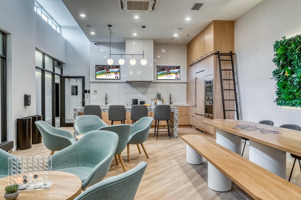 A modern office space with green chairs and a wooden table.