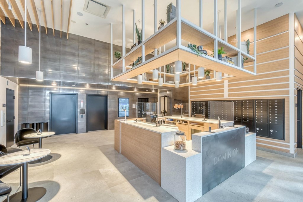 A modern kitchen with a wooden counter and a sign that says "DOMINION".