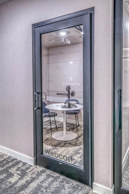 A glass door with a sign that says "Webcast" on it.