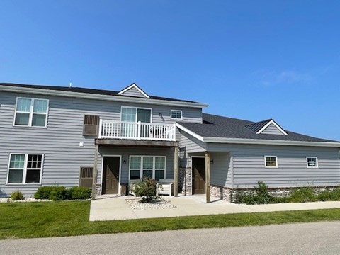 A two-story house with a balcony on the upper floor.