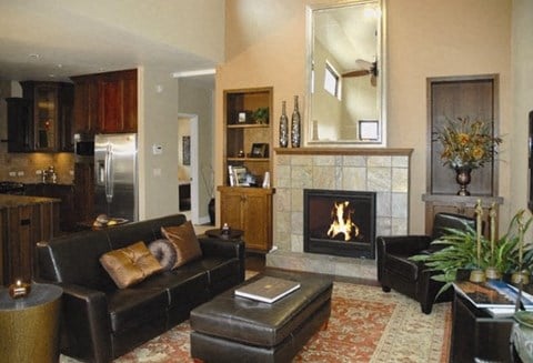 a living room with leather furniture and a fireplace