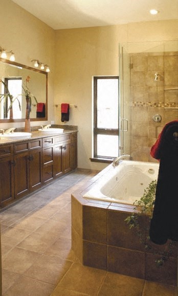a large bathroom with a tub and two sinks