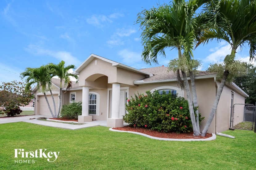 a house with palm trees in front of it