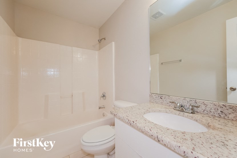 a bathroom with a sink toilet and a bath tub