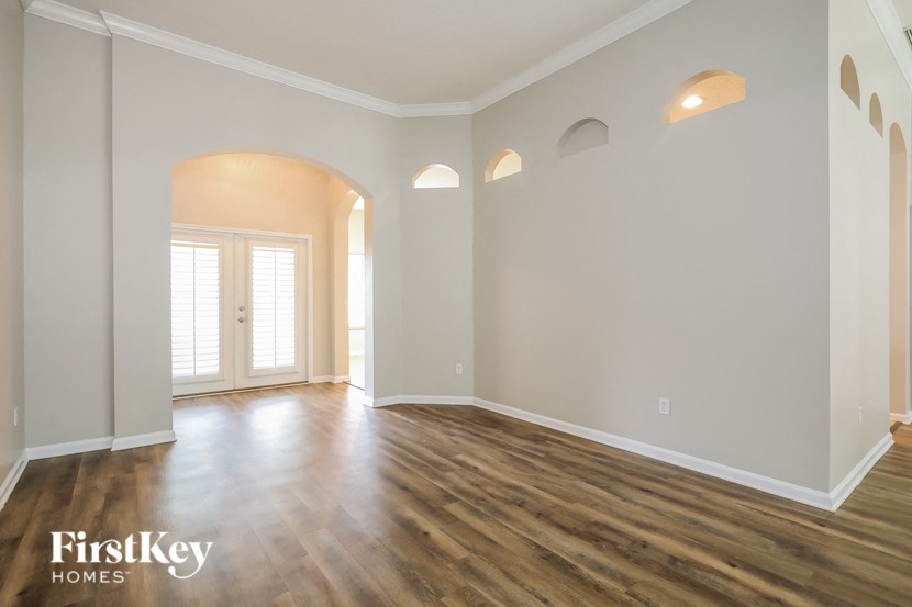 the living room and dining room with hardwood flooring