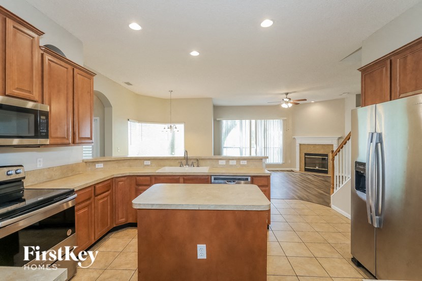 a kitchen with wooden cabinets and stainless steel appliances