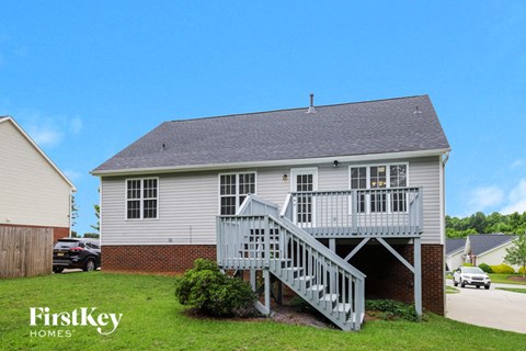 A house with a grey roof and a grey staircase.