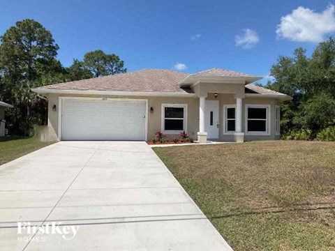 a white house with a driveway and a garage door