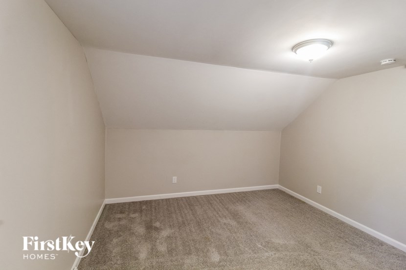 a empty room with carpet and white walls
