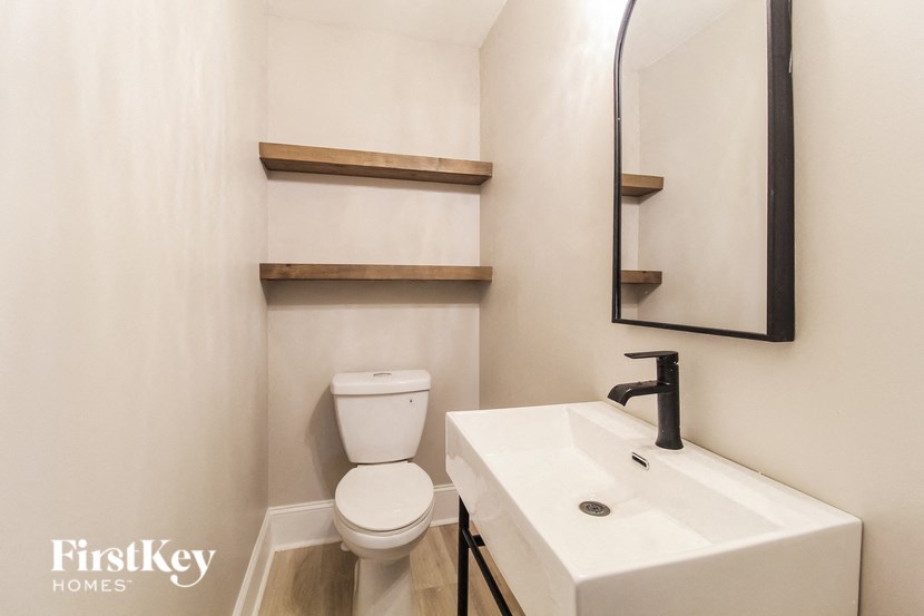 a bathroom with a sink and a toilet and a mirror