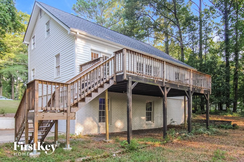 a house with a deck on top of a garage