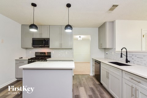 a white kitchen with white counter tops and white cabinets