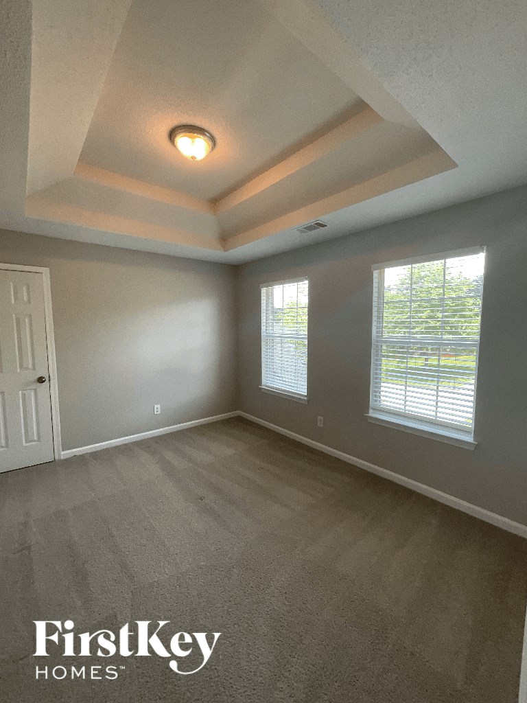 the living room of an empty house with a window