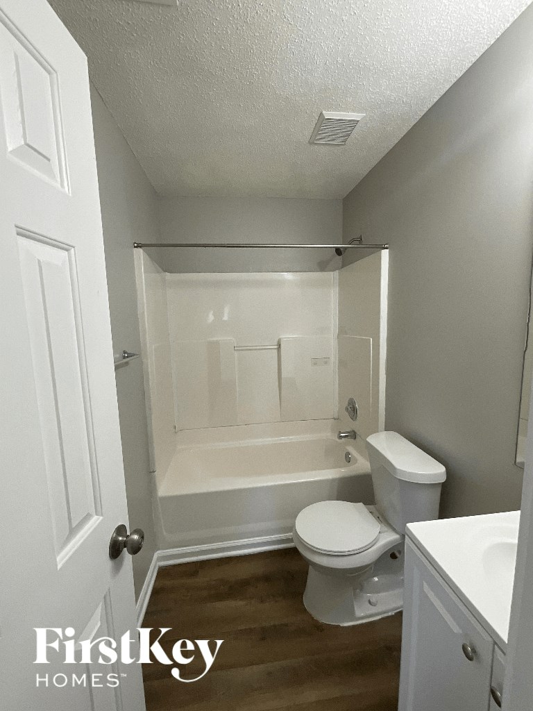 a small bathroom with a toilet and a bath tub