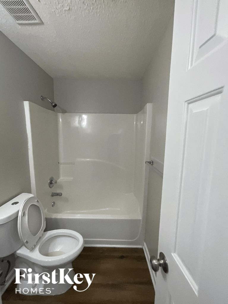 a small bathroom with a toilet and a shower