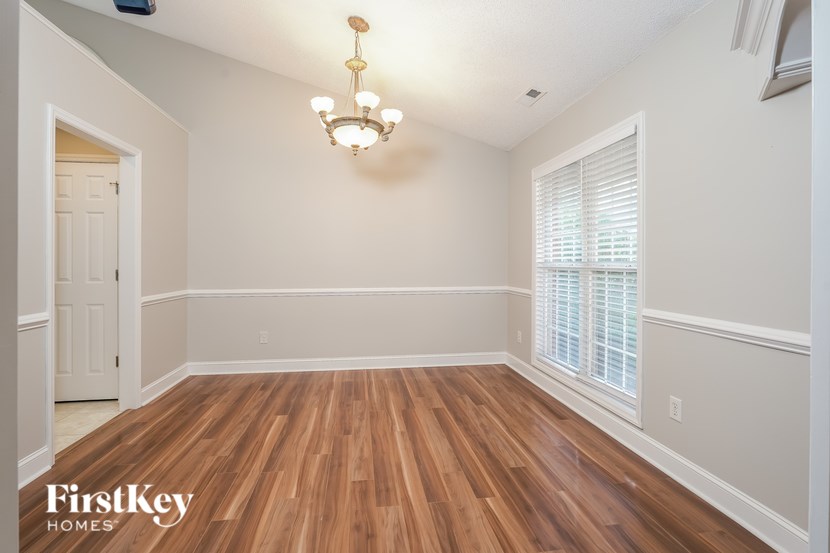 A room with wooden floors and a chandelier.