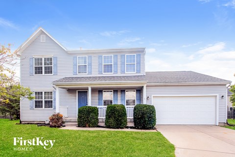 A house with a blue door and a garage.
