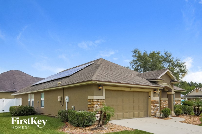 A house with a garage door and a driveway.
