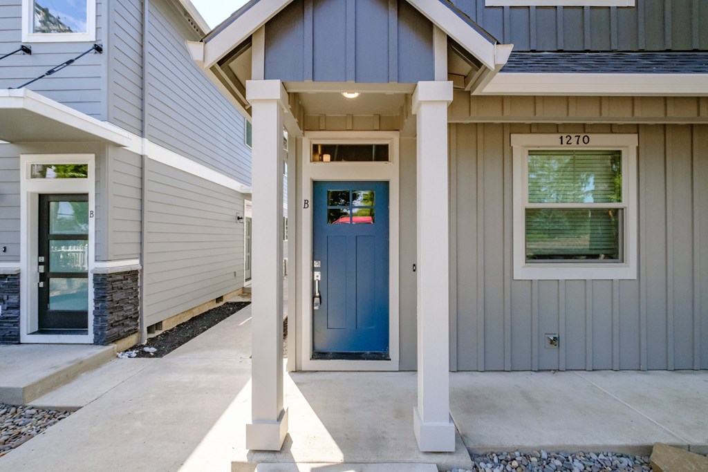 the front porch of a house with a blue door