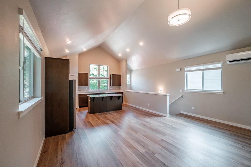an empty living room and kitchen in a new home