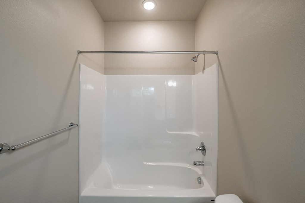 the bathroom has a shower and a toilet in it