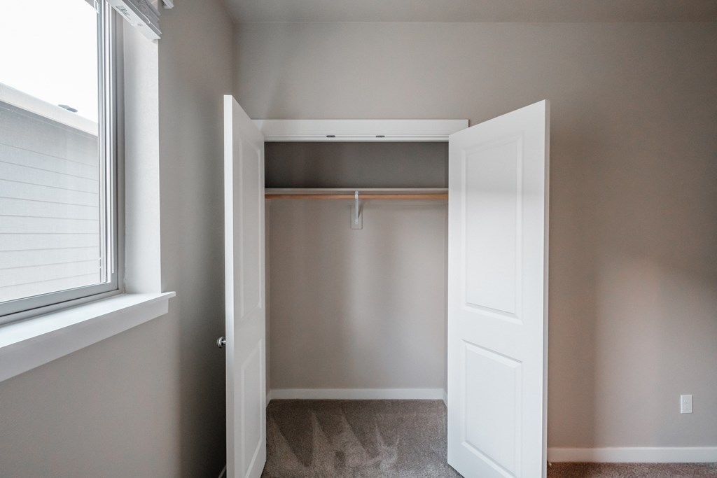 an empty closet in a home with a window