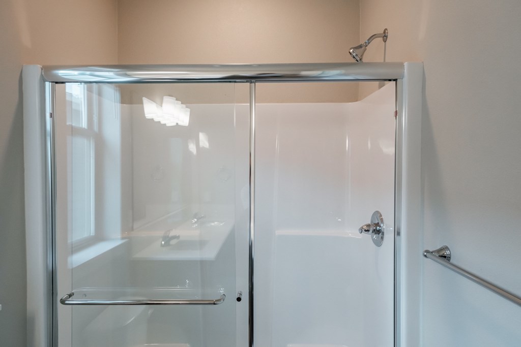 a shower in a bathroom with a glass door